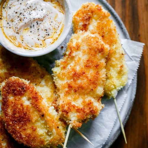On the plate Chicken Strips on a stick recipe with delicious homemade dipping sauce.