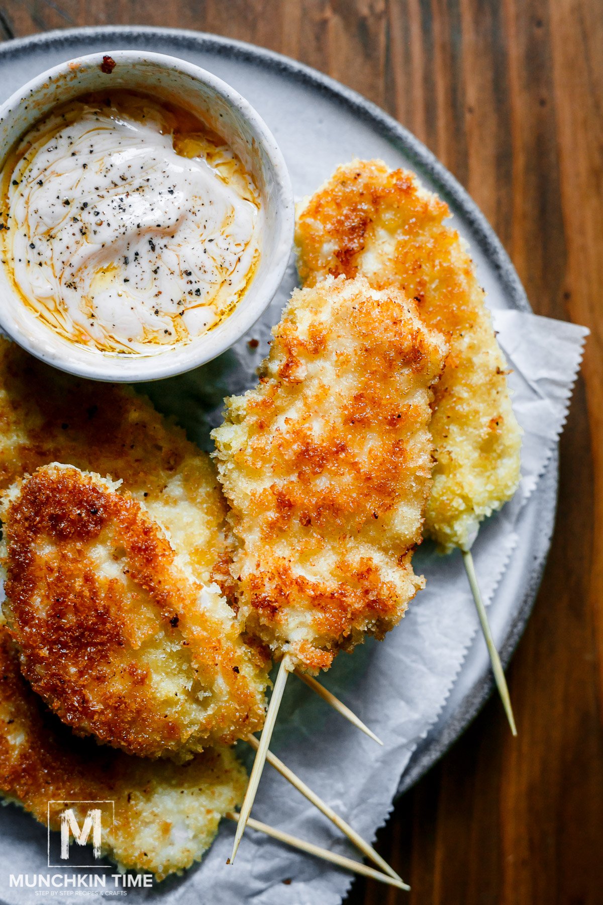 On the plate Chicken Strips on a stick recipe with delicious homemade dipping sauce.
