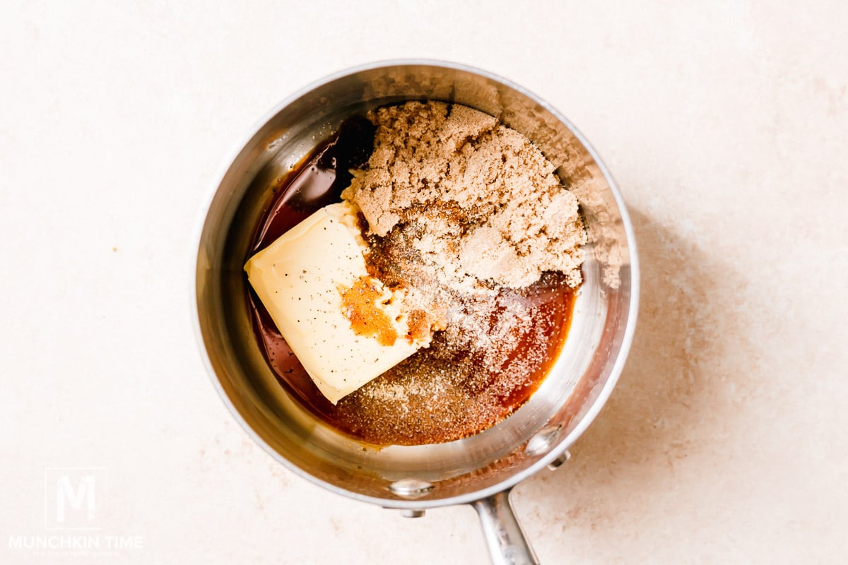 The ingredients for the sauce inside the sauce pan: butter, brown sugar, soy sauce, salt and pepper.