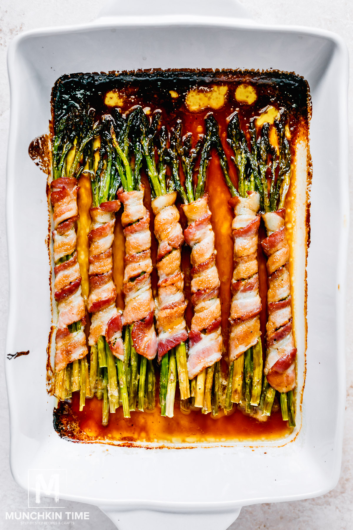 Oven baked asparagus bundles wrapped in bacon.