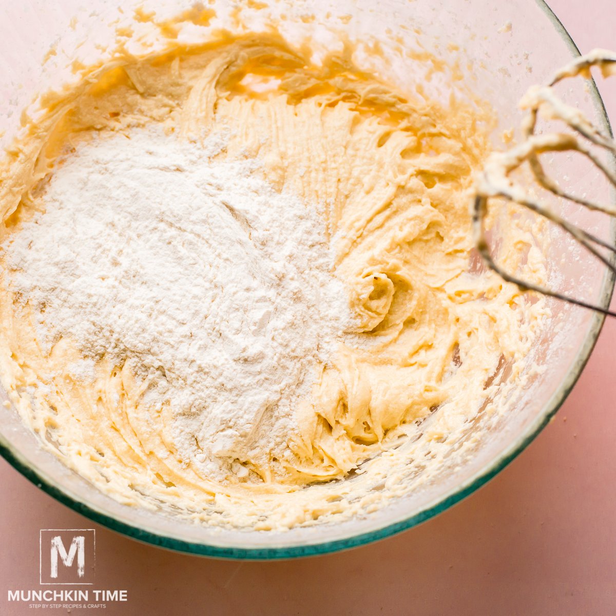 Add flour to the batter 1 cup at a time.