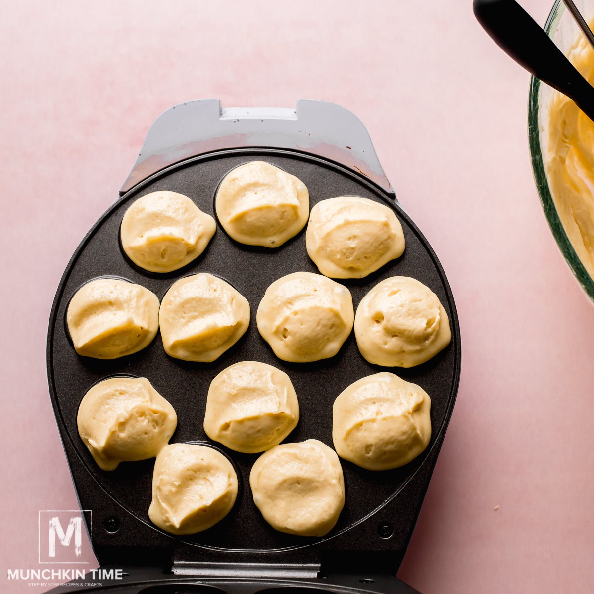 Adding batter into each of the cake pop maker molds