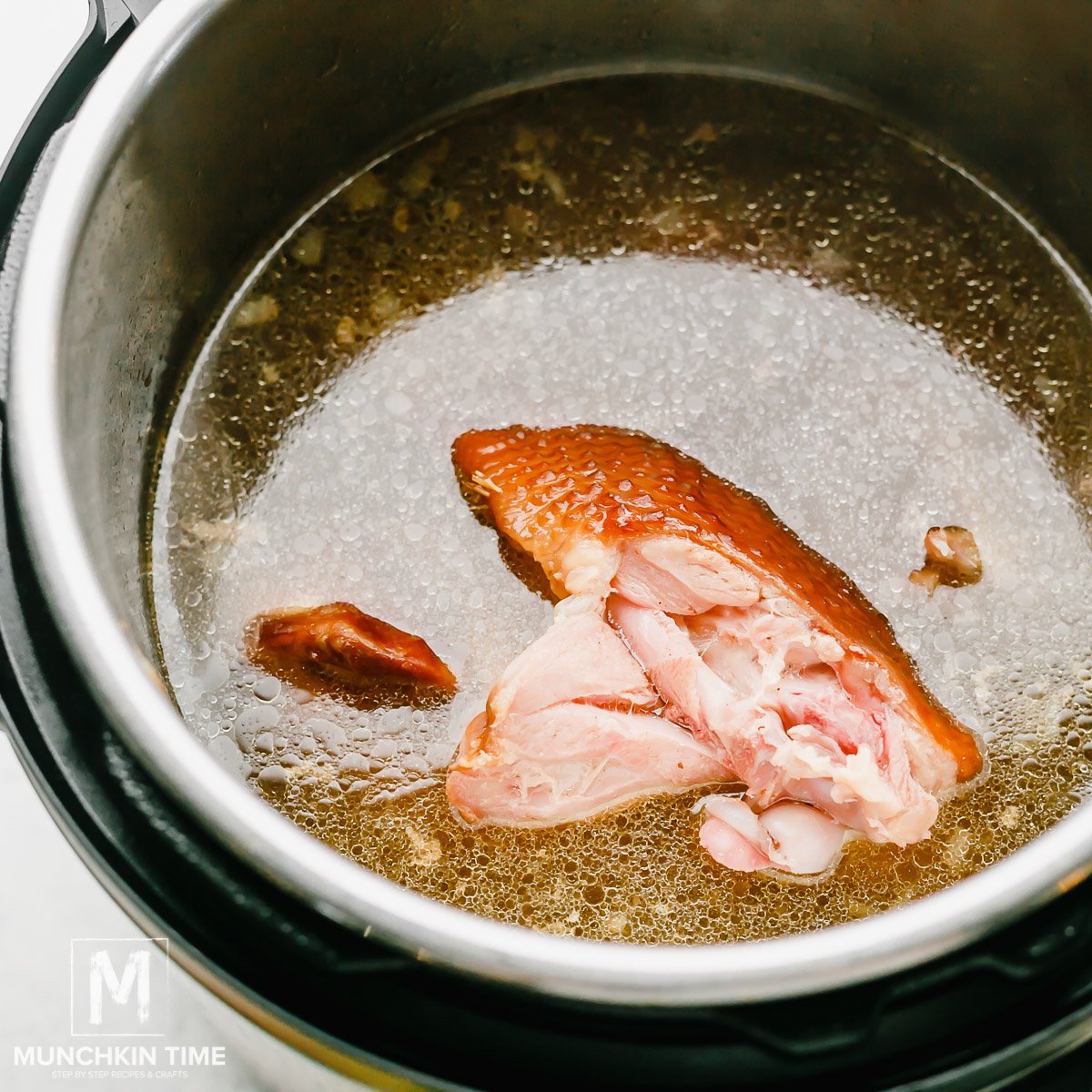 Pour 8 cups of water into the Instant Pot and add smoked turkey wings.