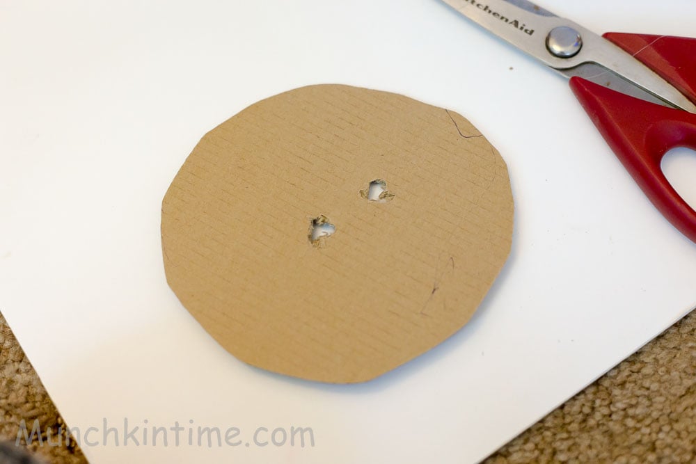 Cardboard with two holes for the head of the piñata.