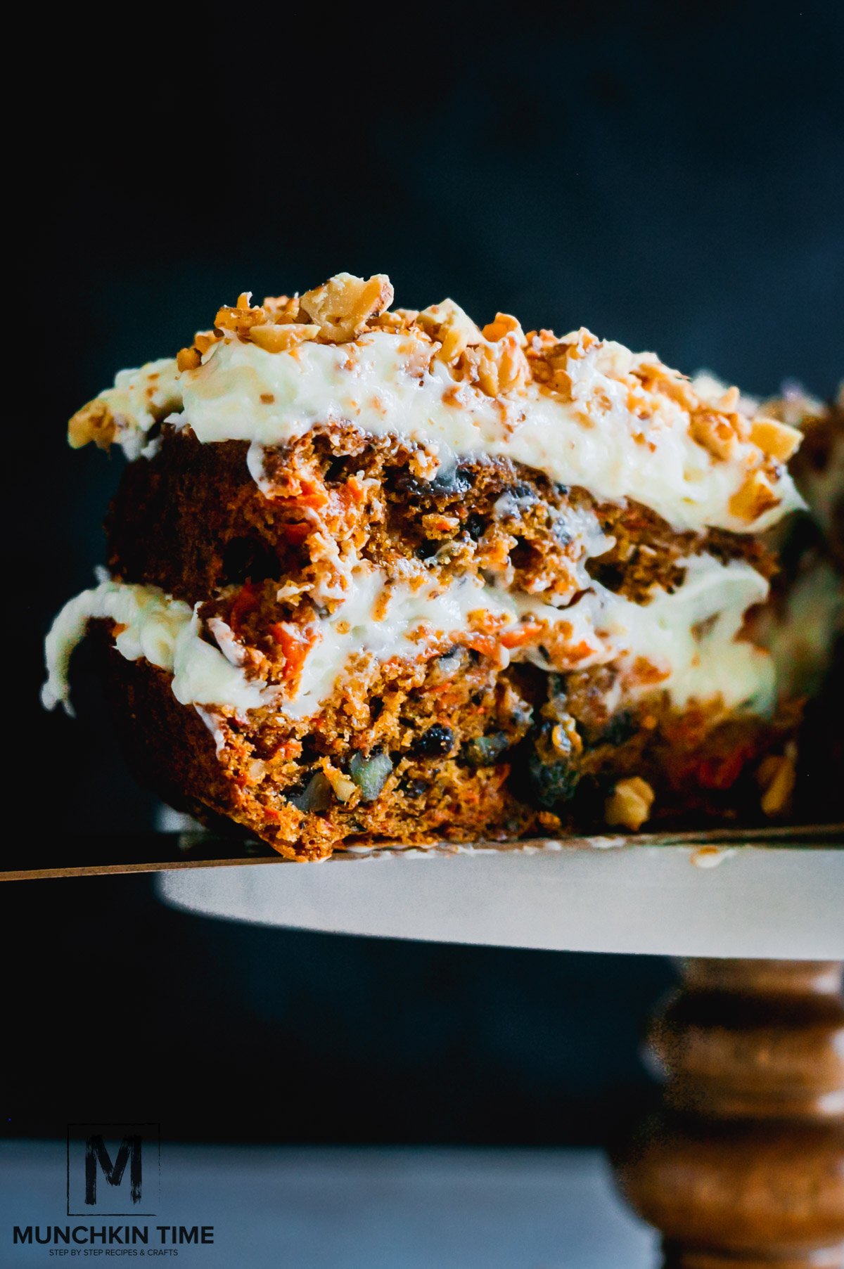 A close up picture of a sliced carrot cake .