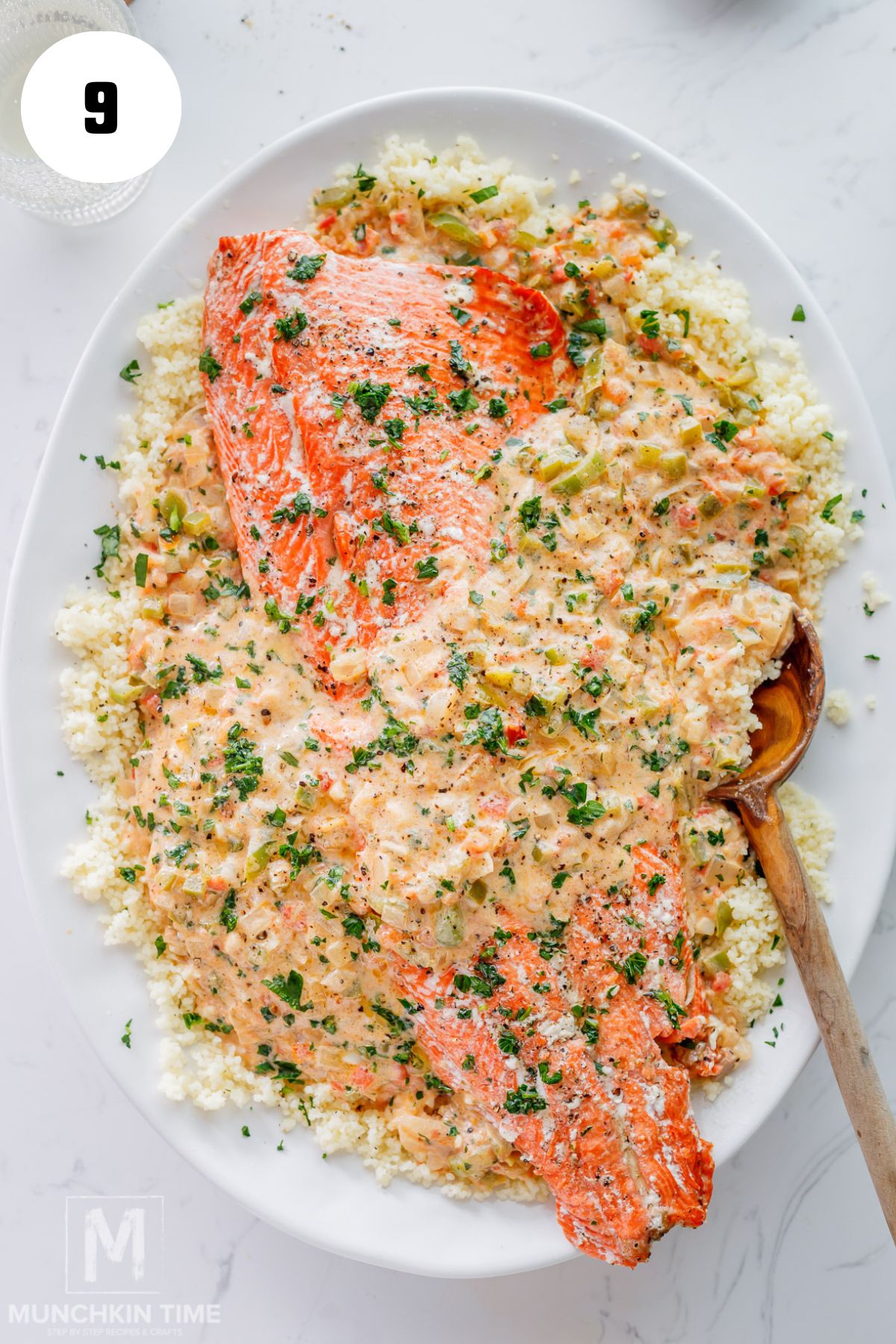 oven baked salmon and tomato sauce added on top of the couscous.