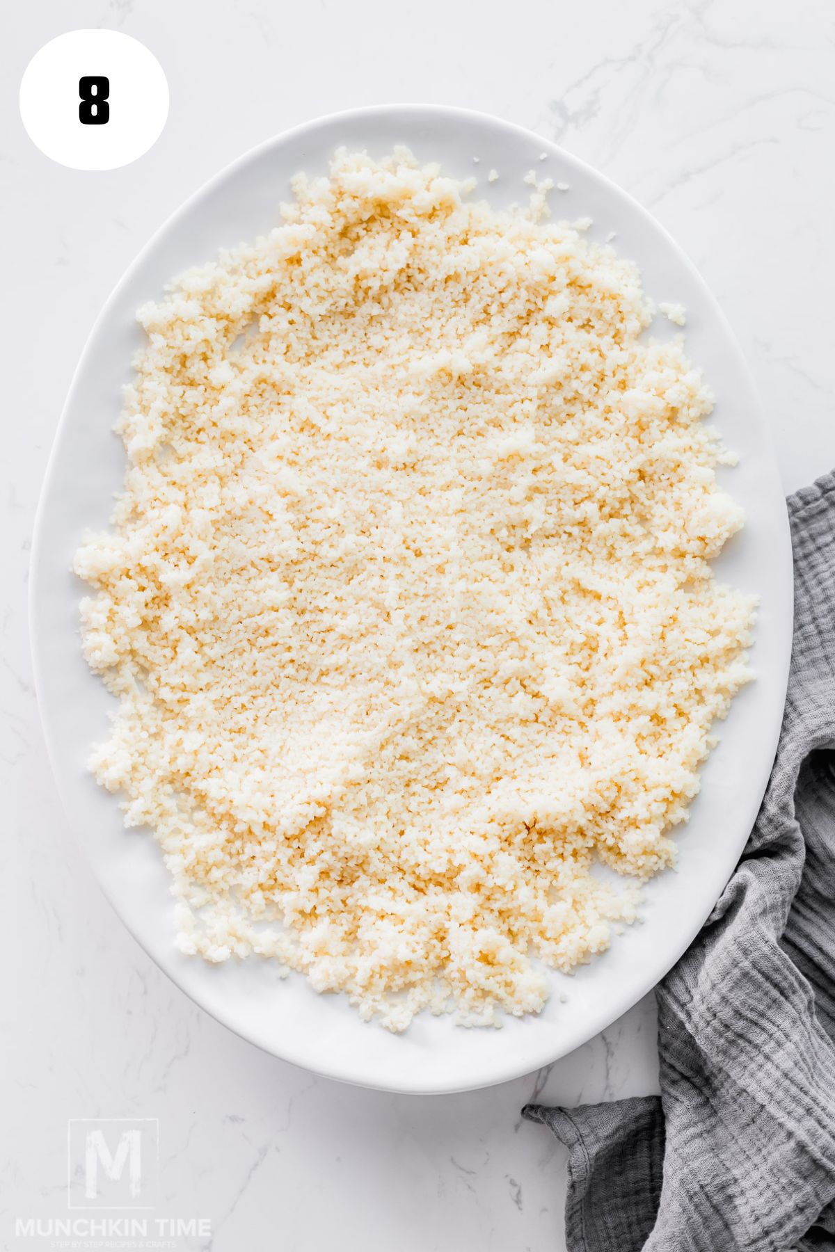 couscous spread on a large white platter.