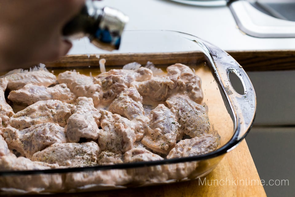 Marinated chicken wings inside the baking sheet.