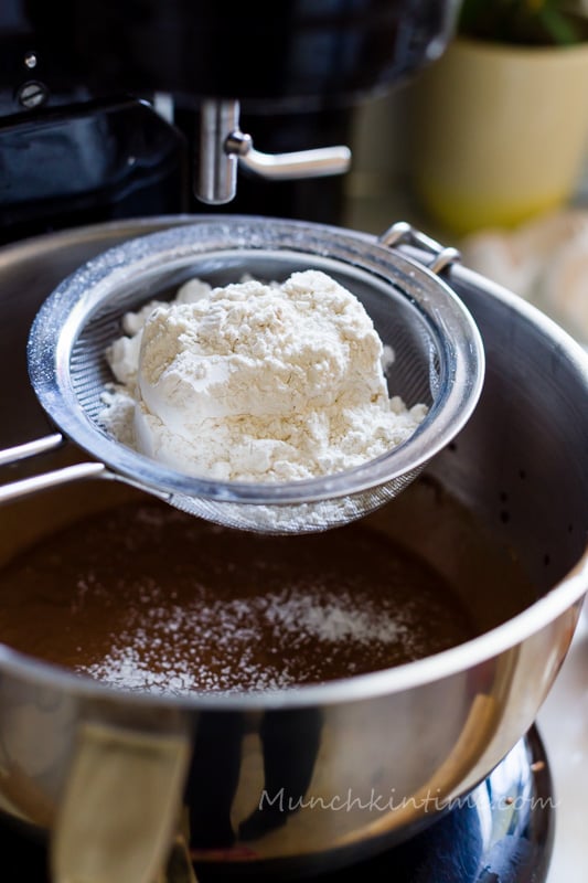 Add flour, cocoa powder and baking powder to sifter and sift it into egg mixture. Mix it with a mixer.