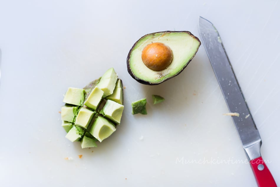 A close shot of sliced avocado and knife.