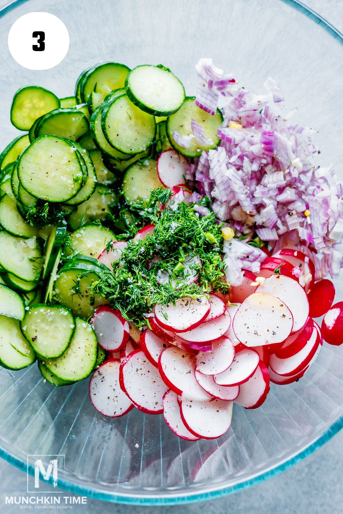 Salad ingredients added to the bowl.