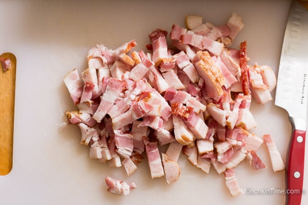 Cut bacon on a cutting board.