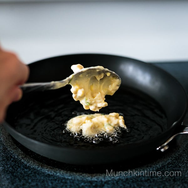 A SPOONFUL OF CHICKEN CUTLET BATTER added to the hot skillet. 