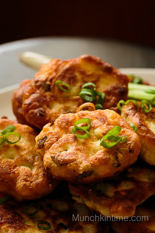 Crispy pan fried chicken cutlets with green onion inside.
