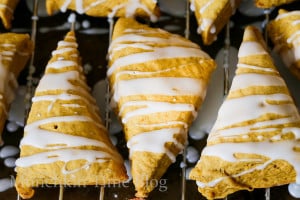 Glazed Mini Pumpkin Scones on a cooling rack.