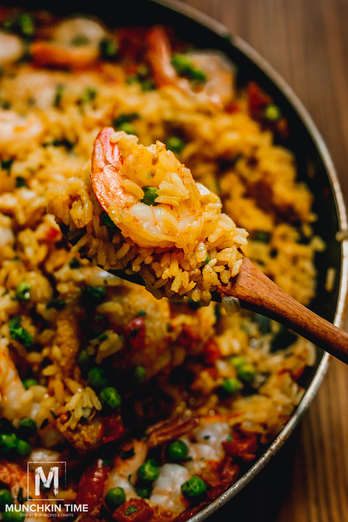 Scoop of seafood Paella on a wooden spoon. 