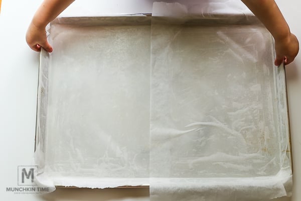 A baking sheet with parchment paper on it.