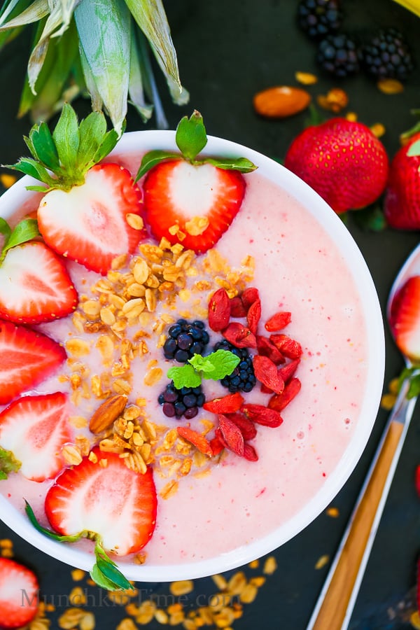 Strawberry Pineapple Smoothie Bowl willed with pineapple, strawberries, blackberries, goji berries and granola.