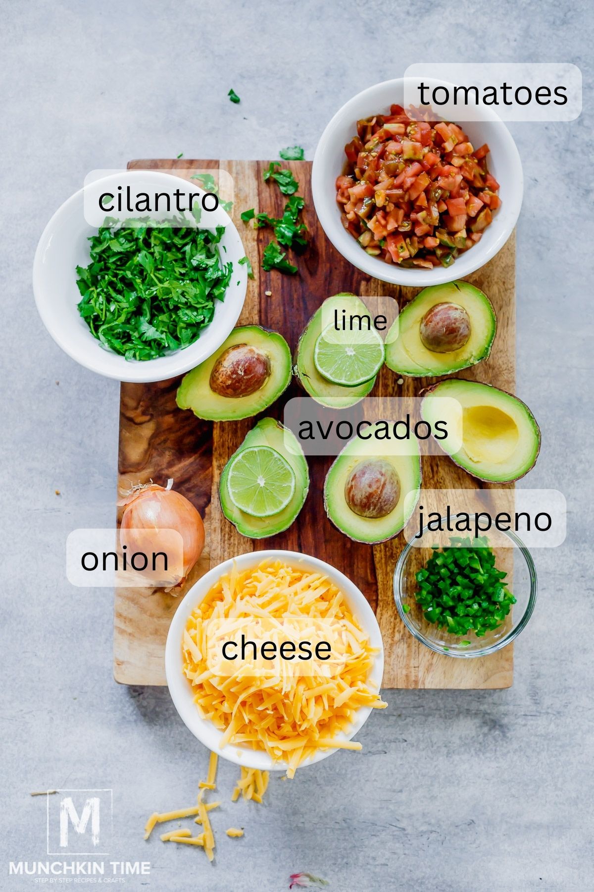 Ingredients for Guacamole on a cutting board.