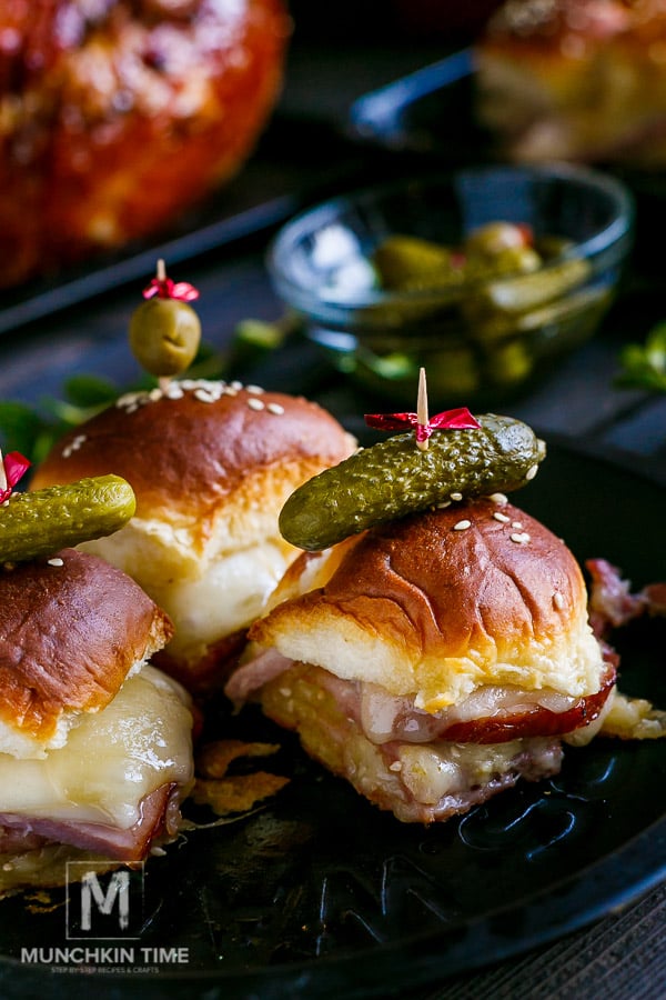 Hawaiian Ham and Cheese Sliders done baking in the oven and served with baby pickle. 