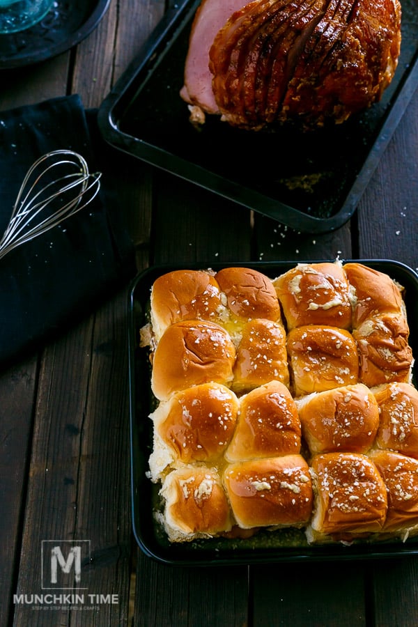 butter with sesame seeds drizzled over the ham sliders.
