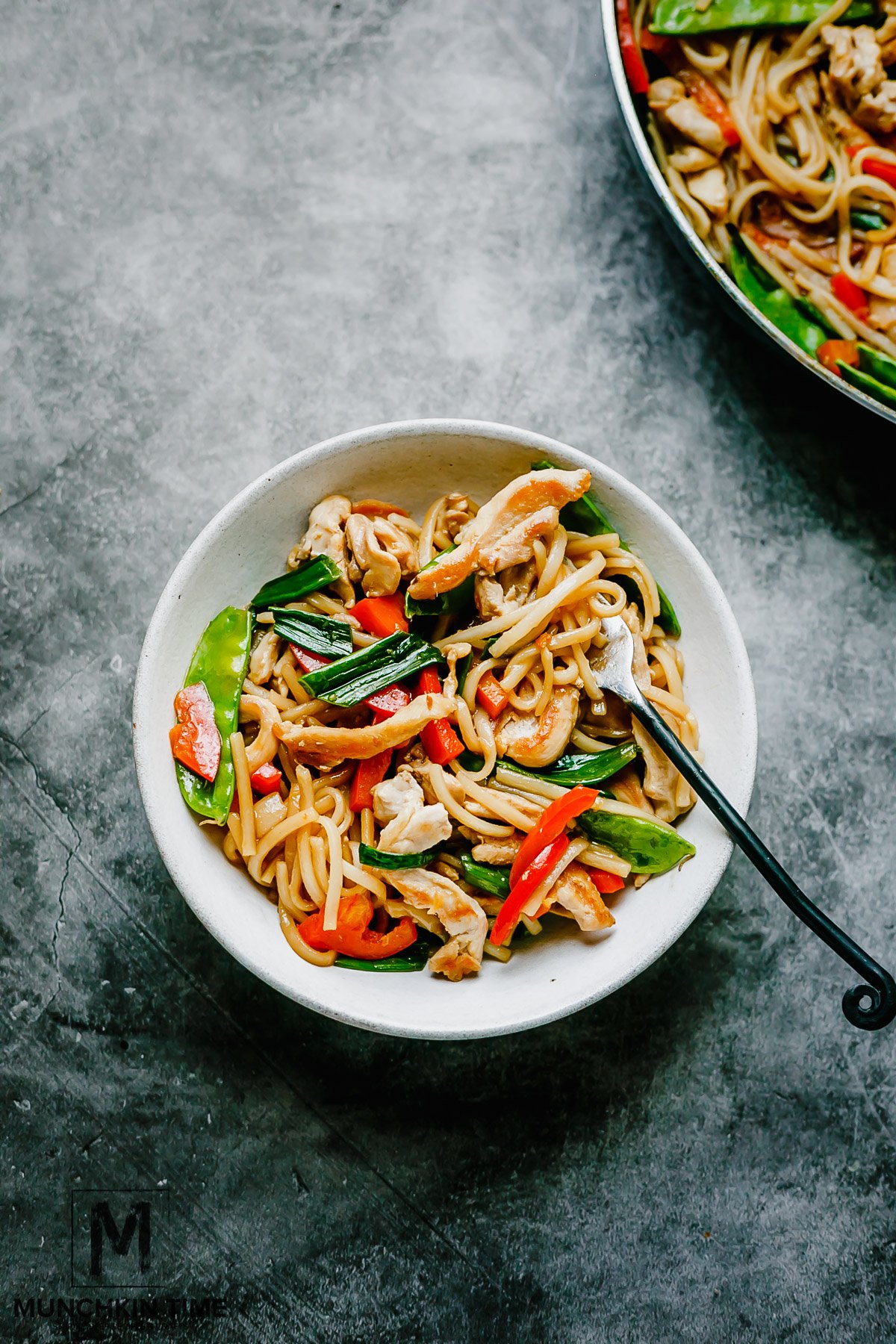 This Chicken Stir Fry Recipe is an Easy Dinner Meal - taking fresh ingredients like organic snow peas, red crunchy bell pepper, green onions and combining them with simple to make chicken stir fry sauce and cooked rice noodle pasta.