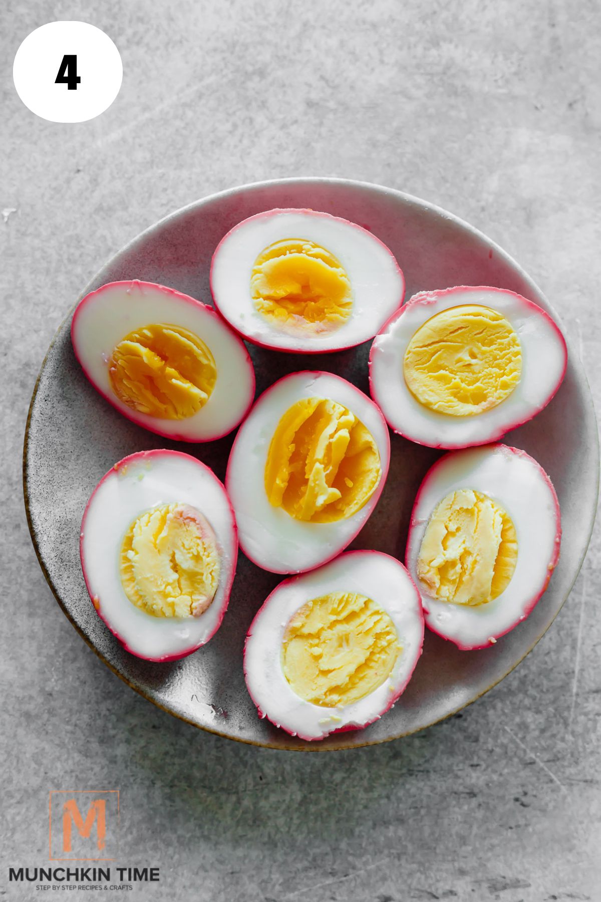 cooked pink eggs cut in half.