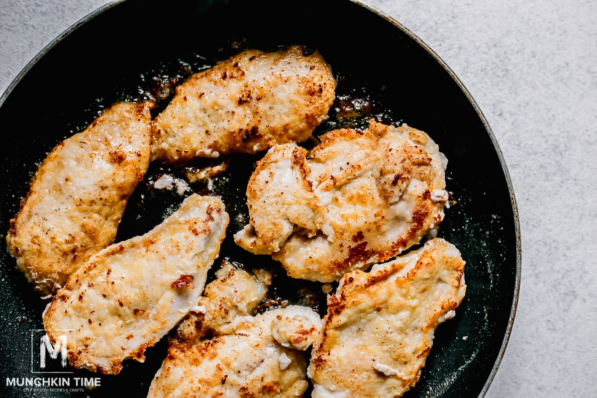 Seared chicken breast inside the skillet.