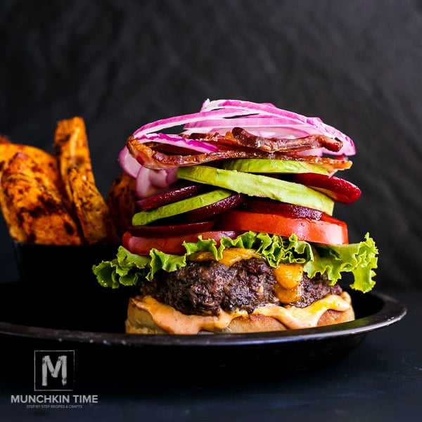 Best Hamburger - homemade patties filled with cheddar cheese, beef patties, lettuce, tomatoes, beets, avocado, bacon and red onion slices