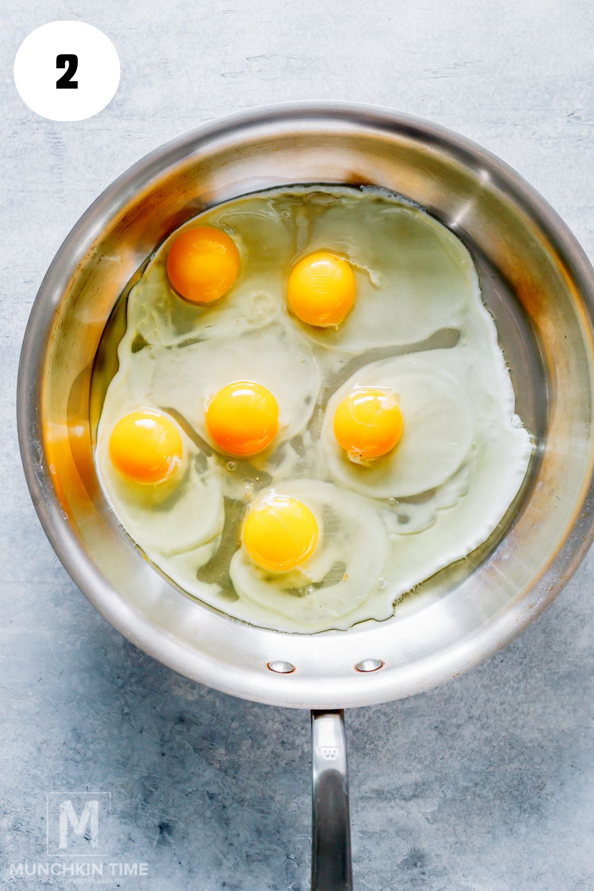 eggs added to the heated skillet with oil.