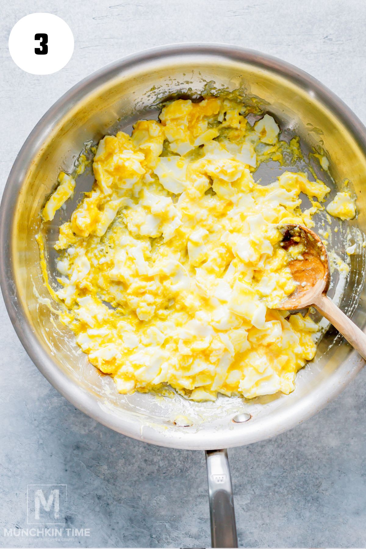 Scrambling eggs in a skillet for an easy fried rice recipe.