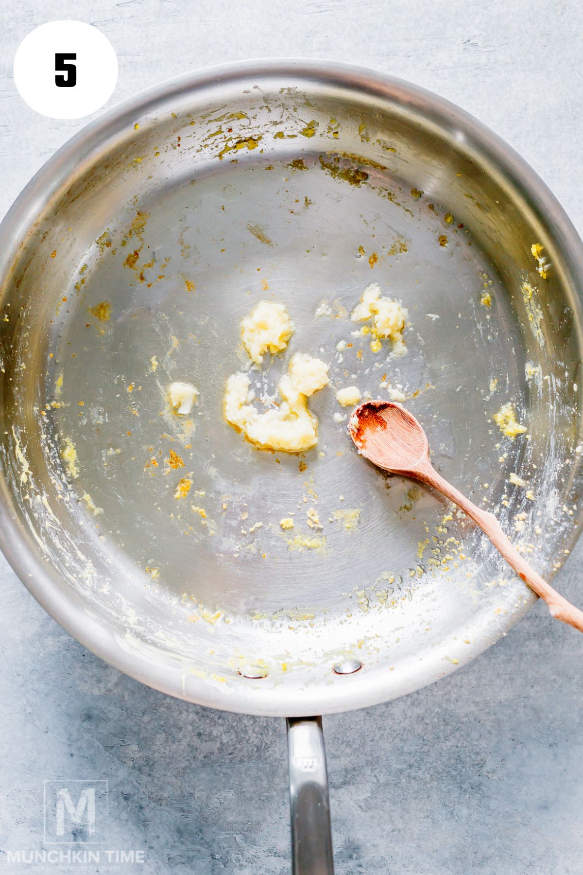 Cooking garlic in oil to start an easy fried rice recipe.