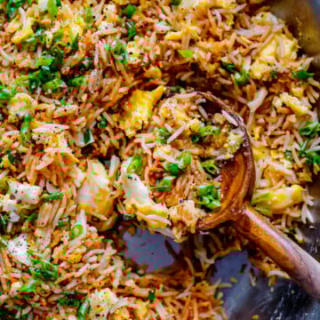 Easy fried rice recipe with egg and green onions served in a bowl.