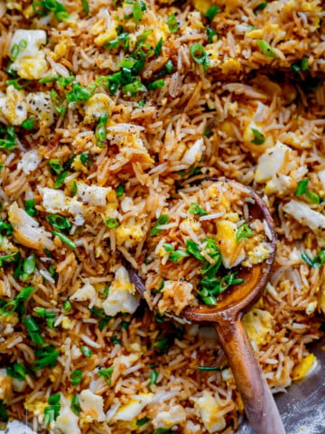 Easy fried rice recipe with egg and green onions served in a bowl.