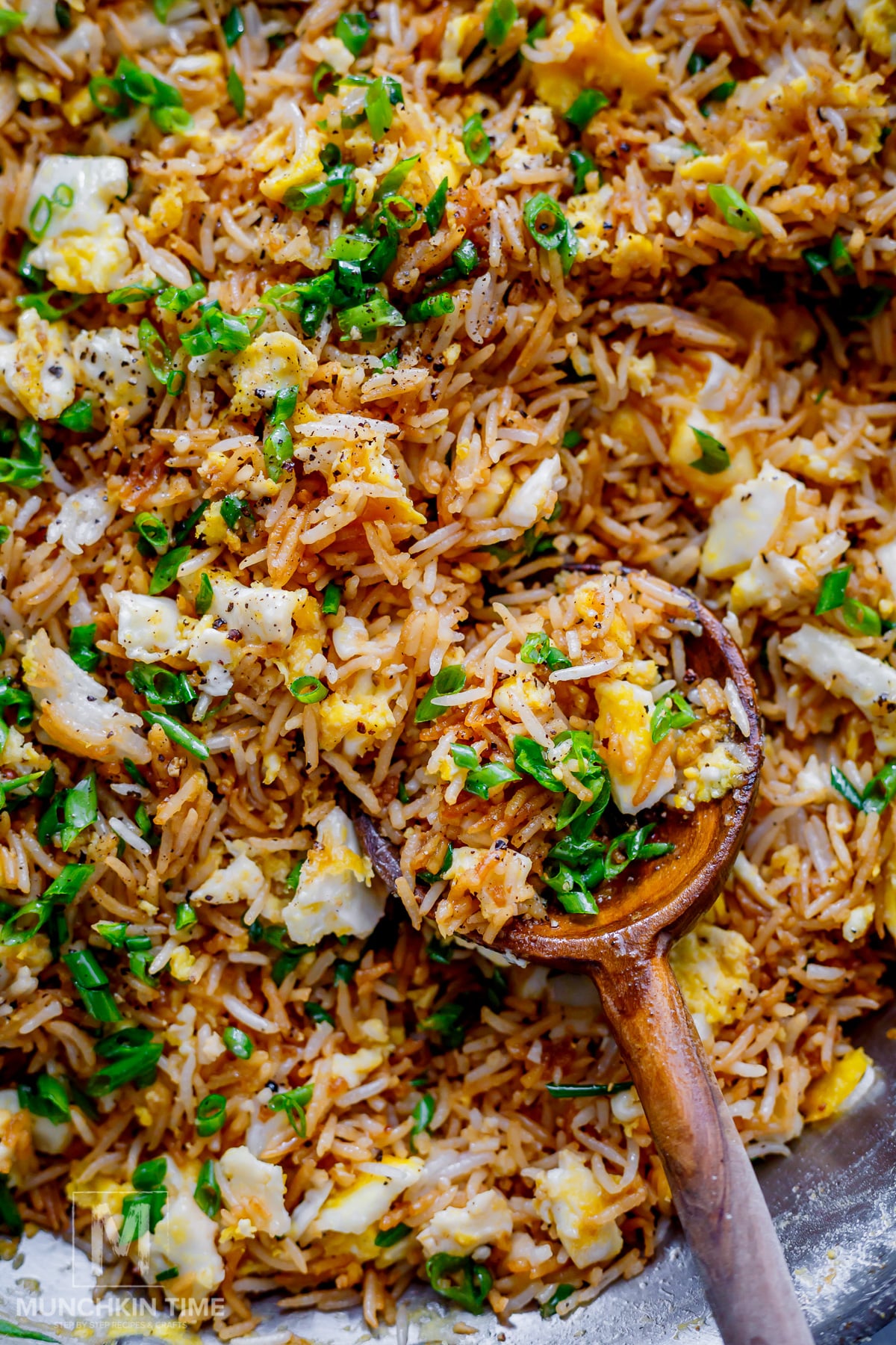 Easy fried rice recipe with egg and green onions served in a bowl.