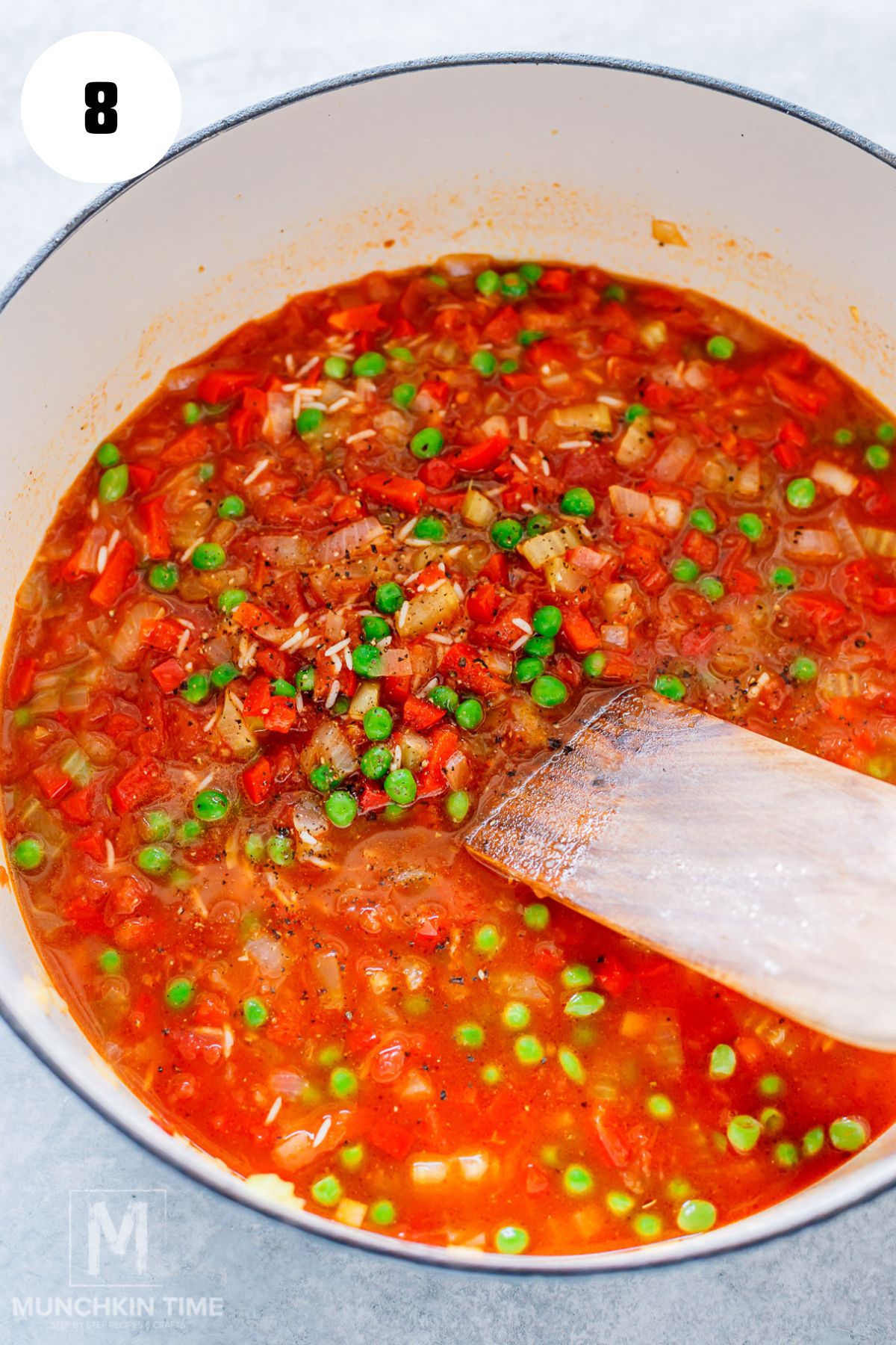 Mixing rice with broth and seasonings for baked chicken thighs and rice