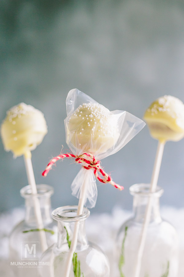 Cake pops wrapped in plastic bag with white sprinkles.