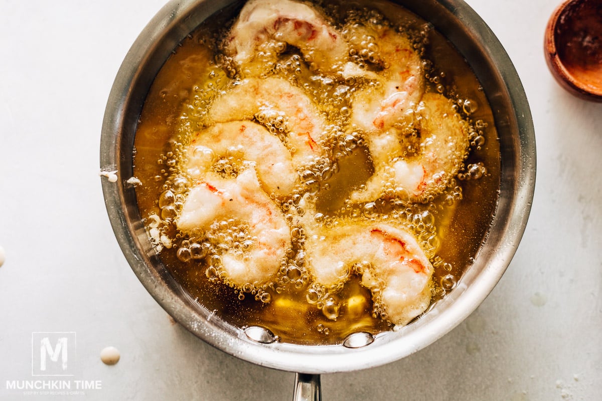 beer batter and shrimp frying in hot oil.