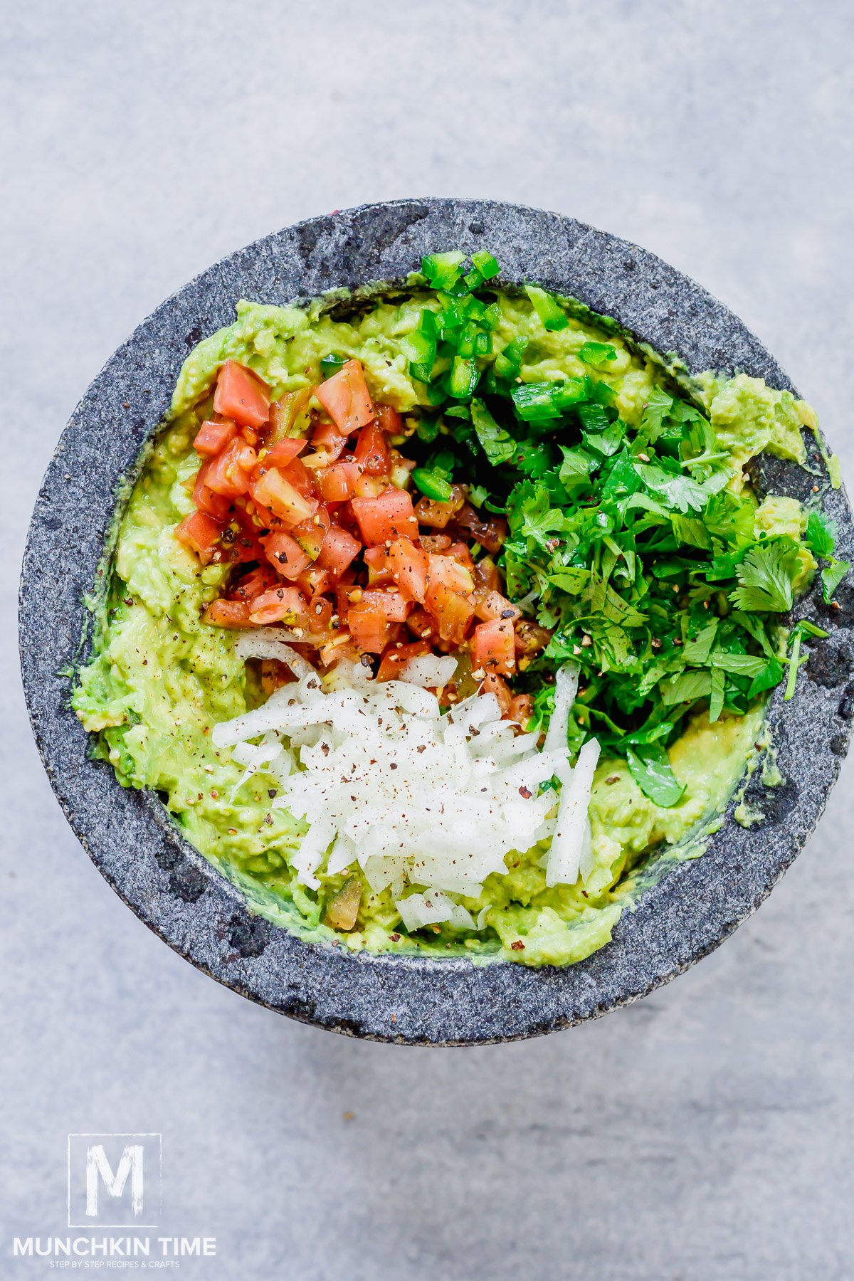 simple guacamole with onion, tomato, cilantro and jalapeno.