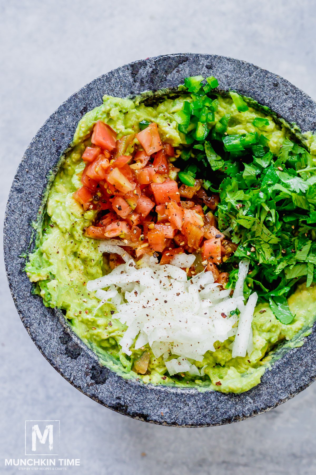 simple guacamole with onion, tomato, cilantro and jalapeno.