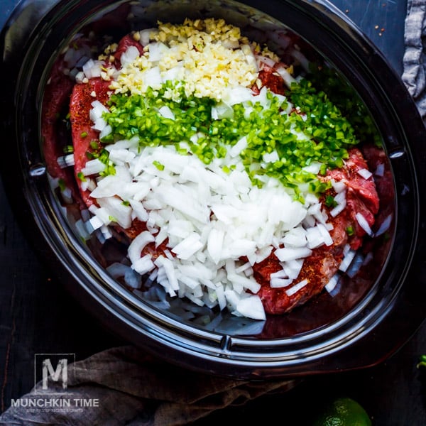 beef and other ingredients inside the slow cooker