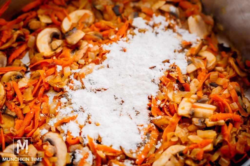 Flour sprinkled over the sauteed veggies