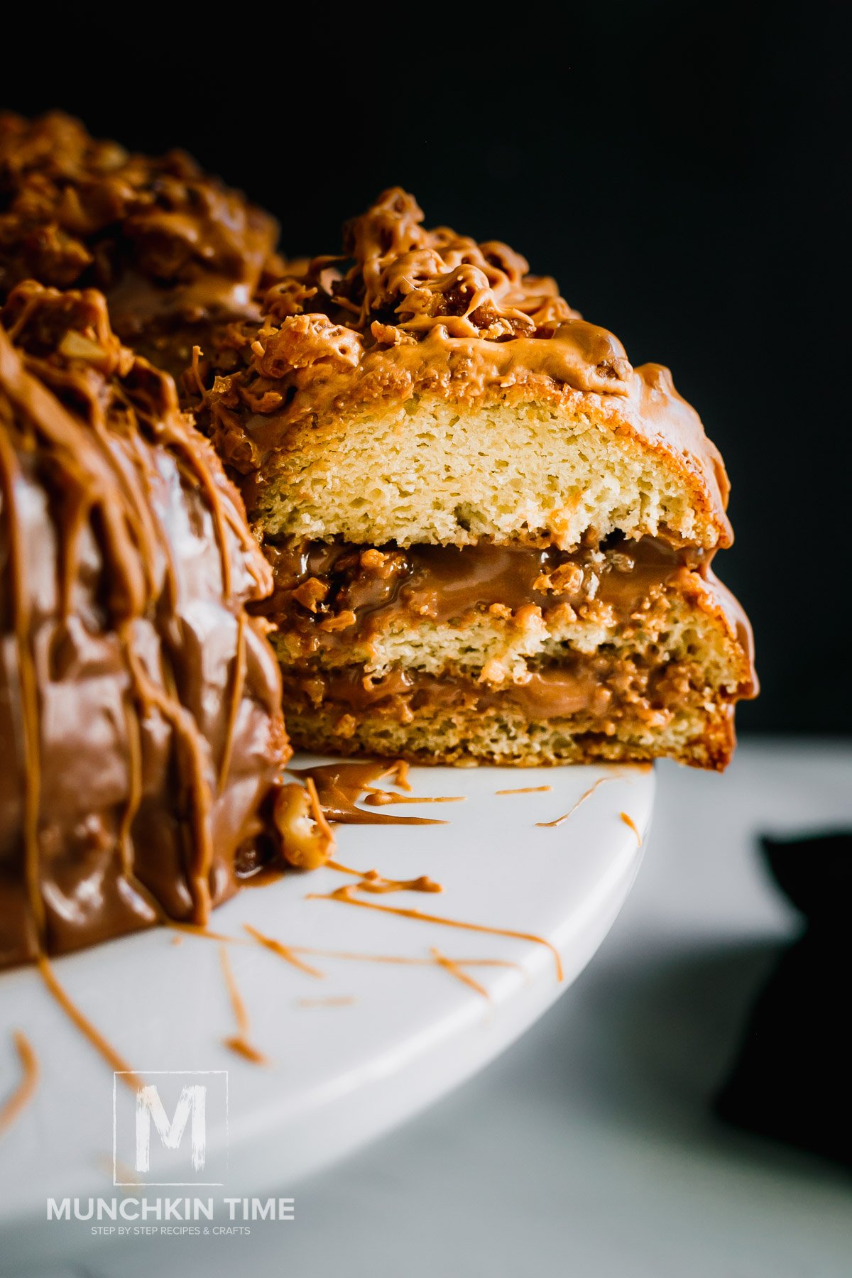 A slice of the Best Vanilla Bundt Cake on a cake stand.