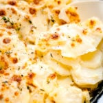 Munchkin Time's Cheesy Scalloped Potatoes in cast iron skillet.