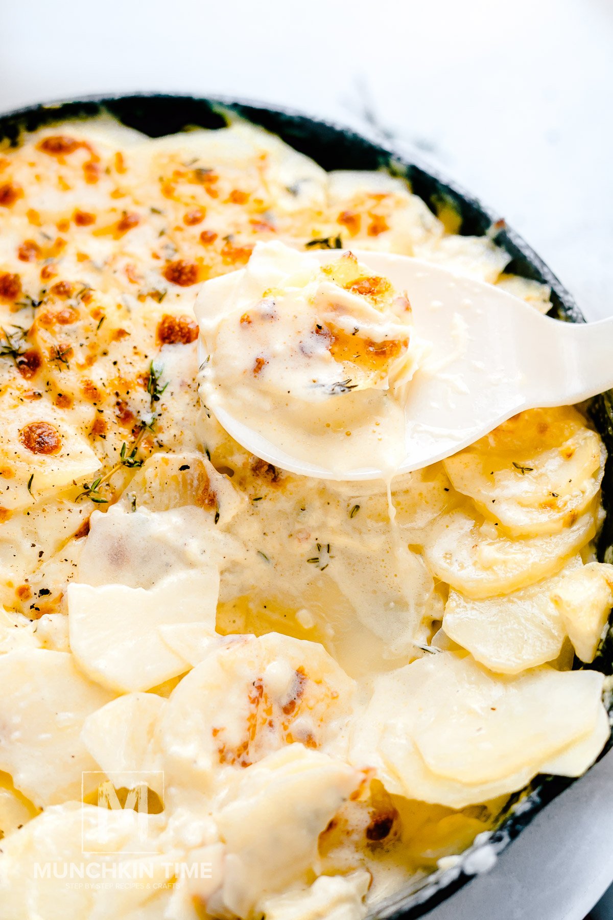A big spoonful of Homemade Cheesy Scalloped Potatoes.