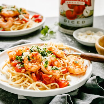 Super Delicious Italian Shrimp Tomato Pasta Recipe with feta cheese and cilantro greens.