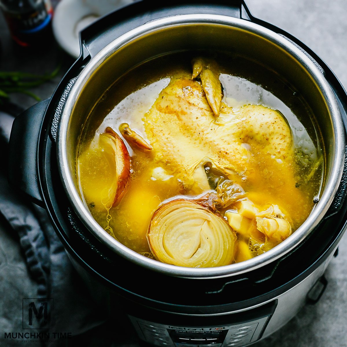 a whole chicken, spices with onion and garlic cooking in an instant pot