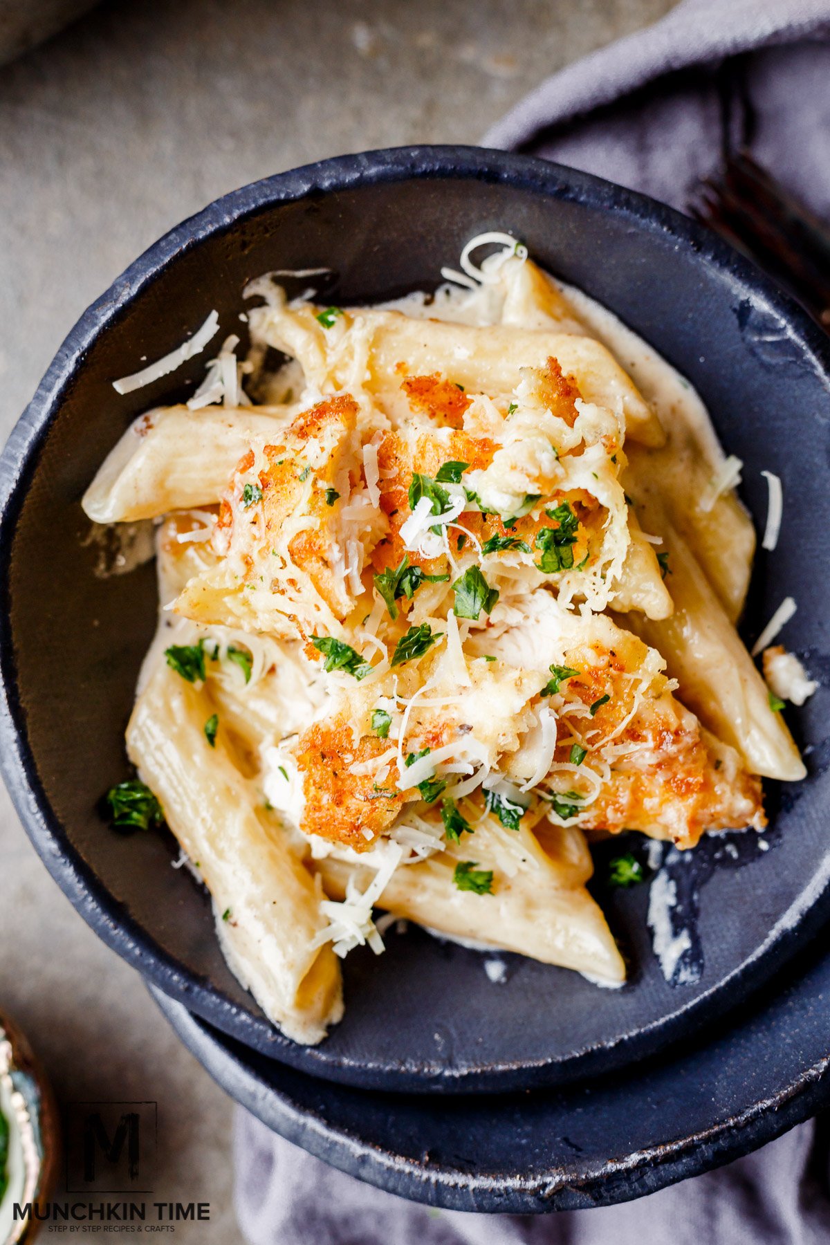 A close up picture of Oven Baked Chicken Pasta in Buttery White Sauce inside the plate.