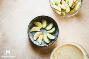 Lay apple slices on the bottom of the pan.