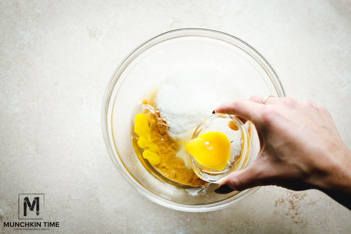 Add one egg into the bowl.